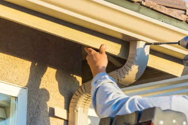 Gutter installation experts working on a Southern Pines home exterior